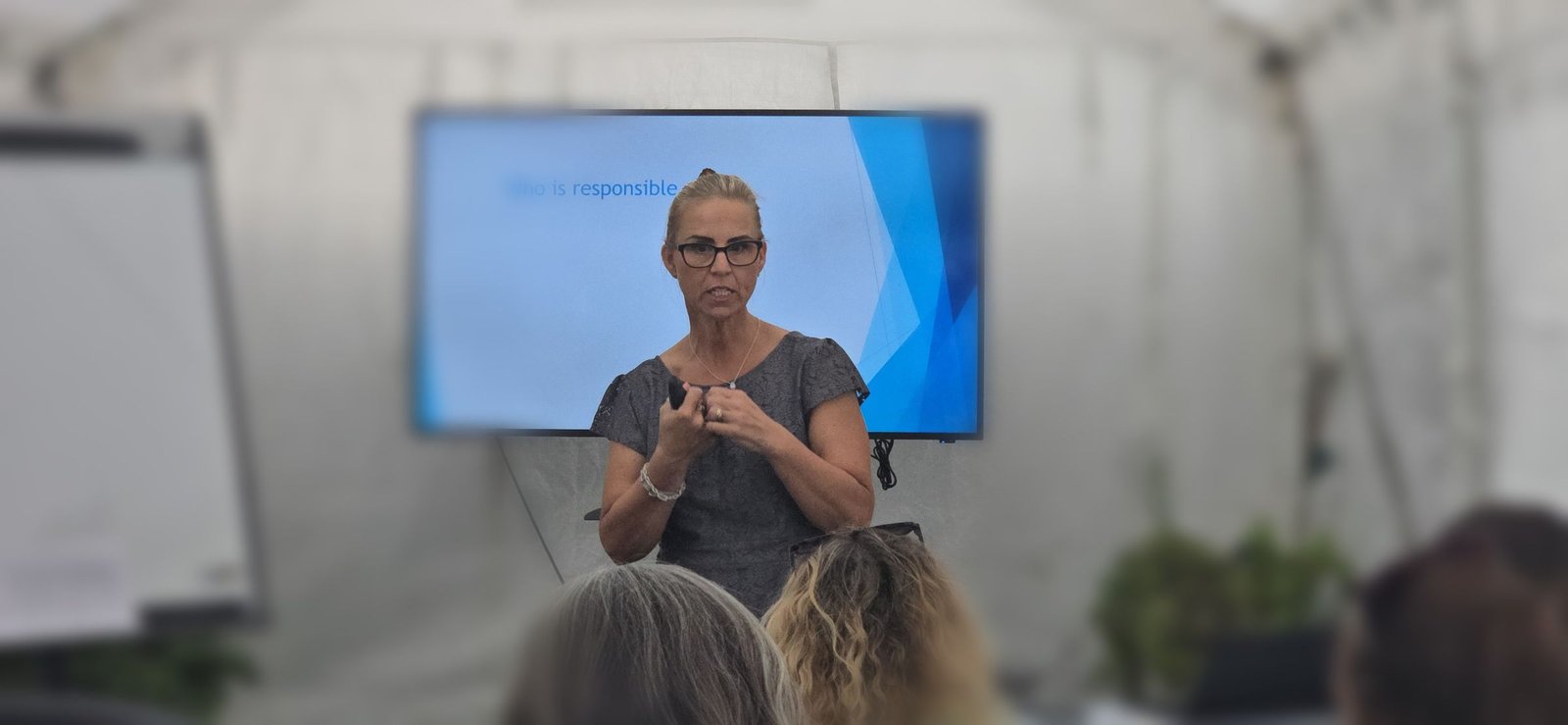 Tracie engaging with the group during a workshop discussion